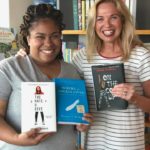 Mississippi writers Angie Thomas and Margaret McMullan hold their novels at Pass Christian Book. Photo courtesy of Scott Naugle and Pass Christian Books.