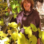 Author Minrose Gwin standing behind a mulberry tree